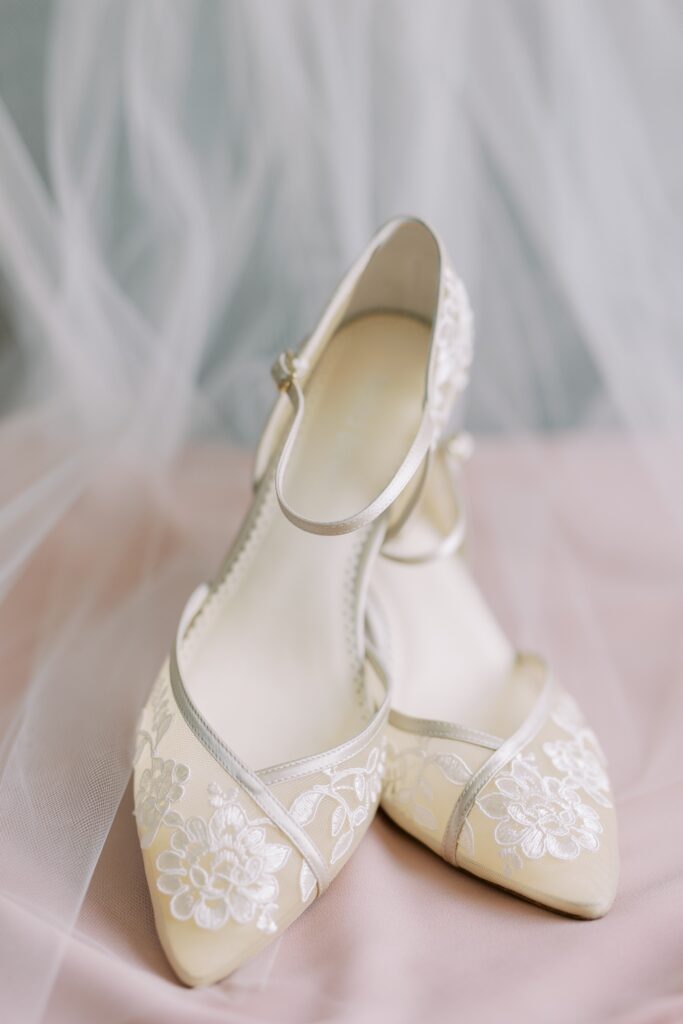 Lace wedding heels on pink fabric													